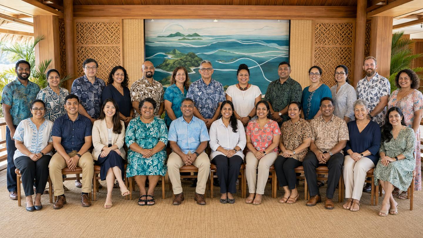 Participants of a capacity-building programme photographed together in a Pacific meeting space.